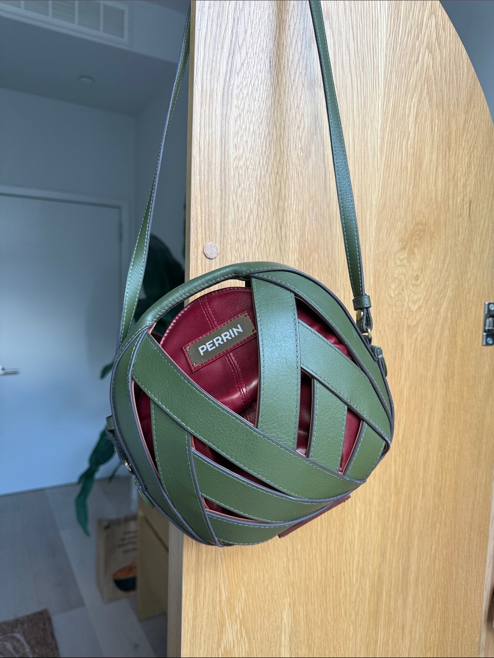 PERRIN Olive Green Woven Round Crossbody Bag with Burgundy Interior